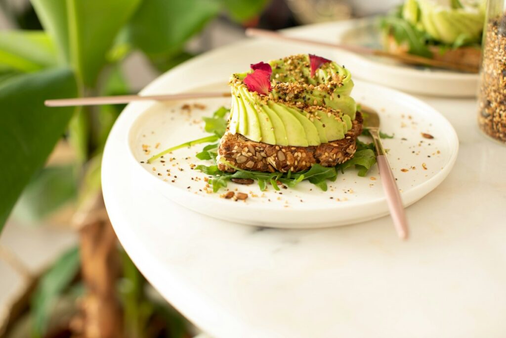 avocado toast on a white plate on a table